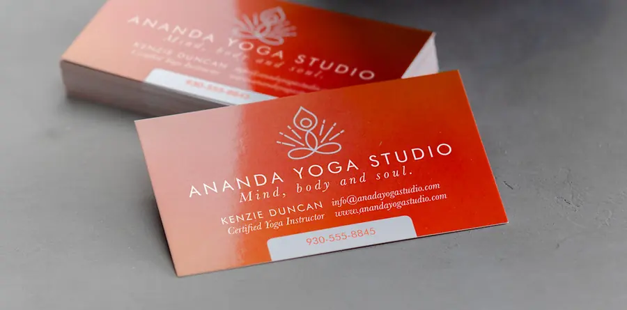 Glossy orange business cards for a yoga studio