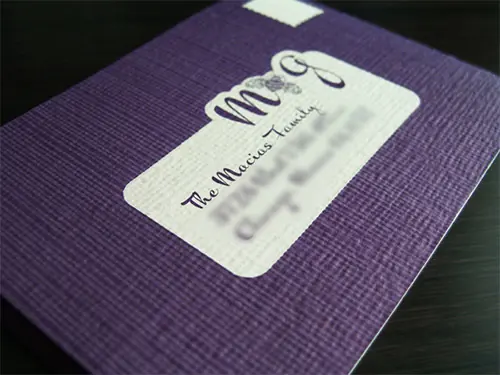 Textured purple card with embossed lettering