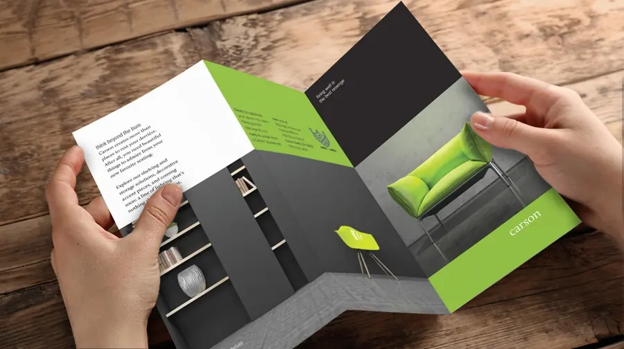 Tri-fold brochure being opened