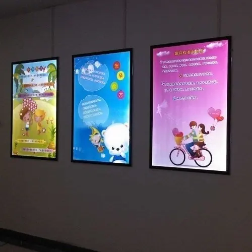 Backlit poster frames on a wall